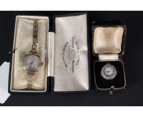 A lady's 9ct gold watch (inscribed to back of case) on rolled gold strap together with a silver Tegra ring watch set with whi