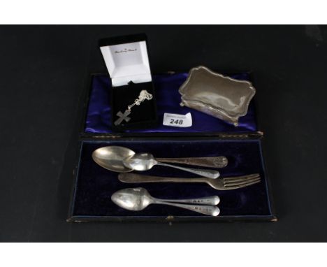 A matching silver spoon and fork, three silver teaspoons, white metal ring box on four legs (no visible marks) and a silver c