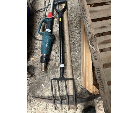 A garden fork together with a pick axe