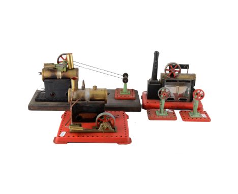 There Mamod live steam stationary engine, and two wheels, all unboxed. (5)