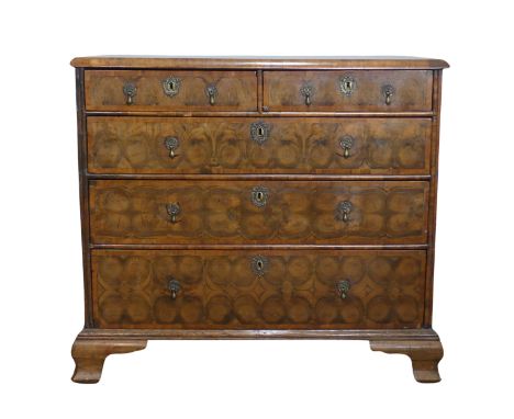 An early 18th century walnut oyster veneered Chest of drawers,&nbsp;the rectangular moulded top with radiating boxwood line i