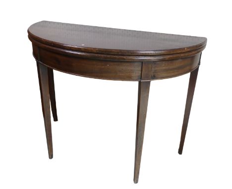 A Georgian mahogany demi-lune card Table, folding top raised on four tapering supports, W 97 cm x H 73 cm x D 42 cm. 
