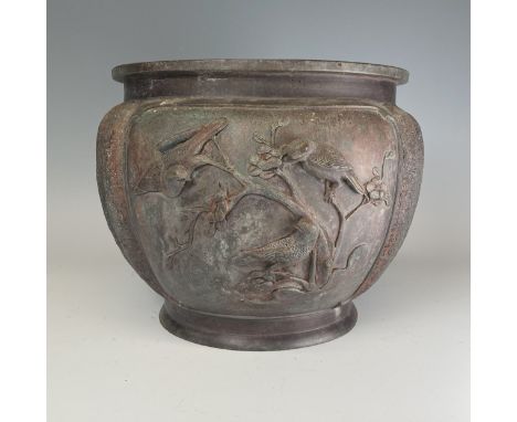 A Japanese Meiji period bronze Jardinière, decorated with moulded birds in relief and pressed characters, drilled holes to ba