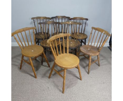 A set of eight country house style rustic oak kitchen Chairs, stick backs over circular seats, raised on turned supports, not