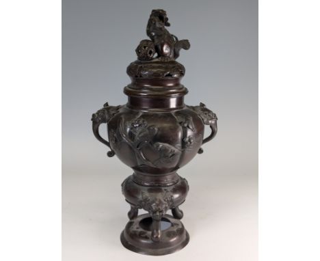 A late 19th century Japanese bronze Censer, raised on three masked legs, with central pumpkin shaped body with birds and foli