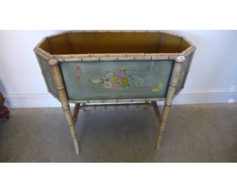 A faux bamboo painted floral decorated planter - Height 71cm x 82cm x 42cm