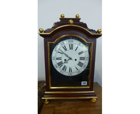 A bracket clock in a painted case with an enamel dial striking on a bell with a spring driven movement - Austrian