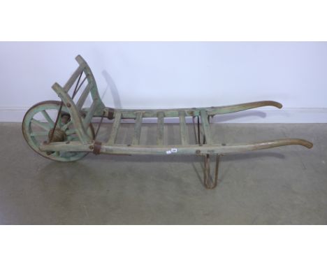 A late 19th century single wheel market barrow with original paint - Length 180cm 
Condition report: Good decorative item 