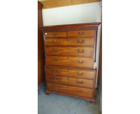 A 19th century mahogany chest on chest with a blind fretwork frieze above a series of eight drawers on shaped bracket feet - 