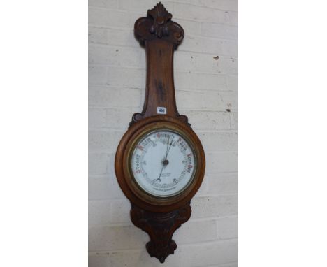 An oak aneroid barometer - Height 90cm 
Condition report: Missing its thermometer 
