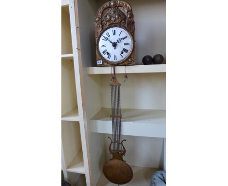 A gilt metal comtoise double weight wall clock with a 21cm enamel dial - Height 40cm