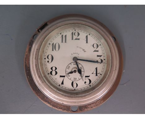 A Swiss made Octo dashboard clock, Arabic numerals to white enamel dial with subsidiary second hand dial at 6 o'clock, non ma