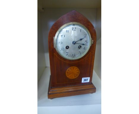 An eight day mahogany case with inlay French mantel clock, strikes hours and half hours 
Condition report: With key and pendu