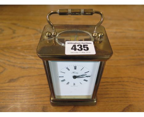 A brass cased carriage clock by Henley ,Roman numerals to white enamel dial
