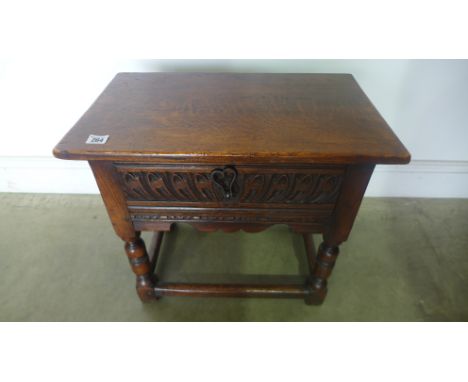 A 1930's carved oak stool with a carved drawer with a nice patina
