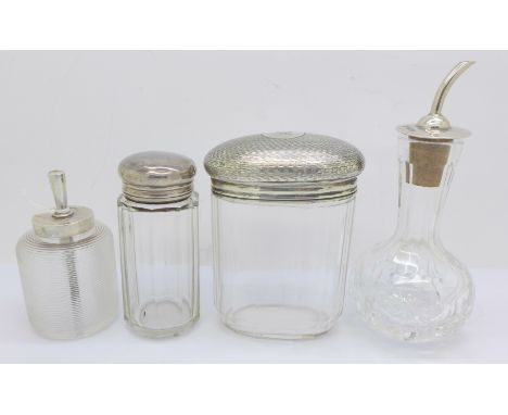 Two silver topped bottles, a silver topped glass oil pourer and one other silver topped item (4) 