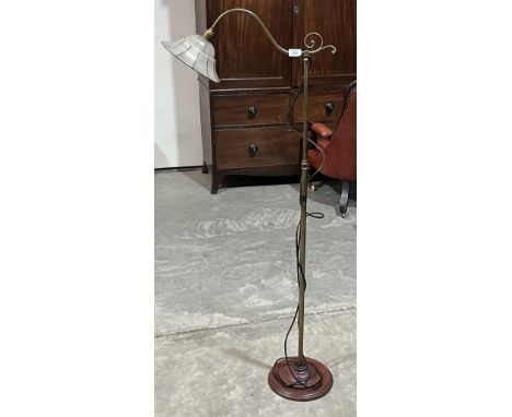 A brass telescopic lamp standard with glass shade