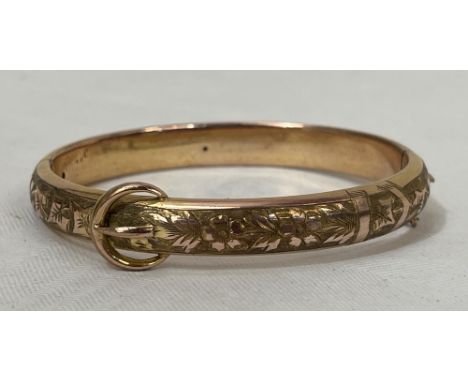 A Victorian gold foliate chased hinged buckle bangle. 20g gross. Cased