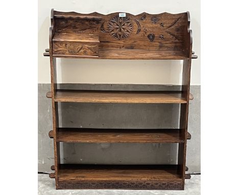 An Arts &amp; Crafts oak open bookcase of four shelves, the top shelf with integral pipe rack and smoker's box. 31"w x 42"h