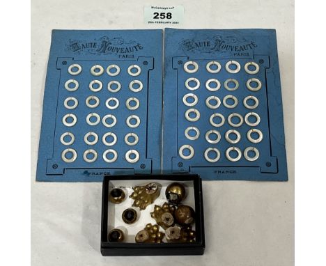 Two French trade cards of mother-of-pearl button rings and a collection of caddy feet.