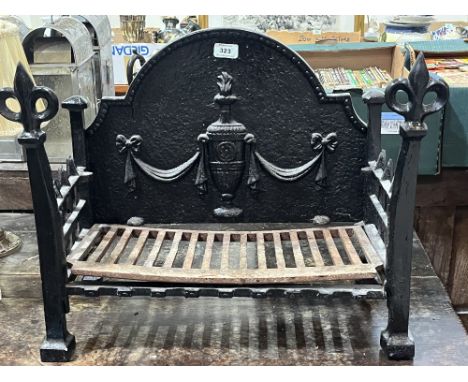 A cast iron fire grate. 20" wide