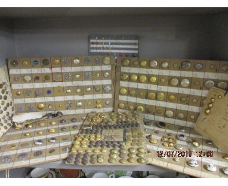 A collection of dressmakers button examples to include Military examples, together with a buckle and watch chains 
