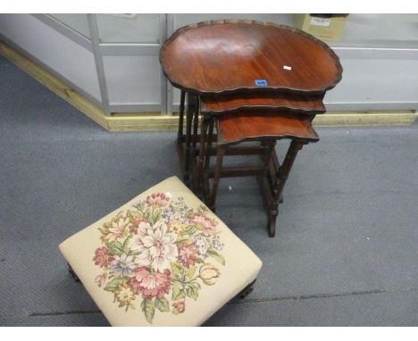 An early 20th century mahogany, kidney shaped nest of tables and a reproduction tapestry foot stool 