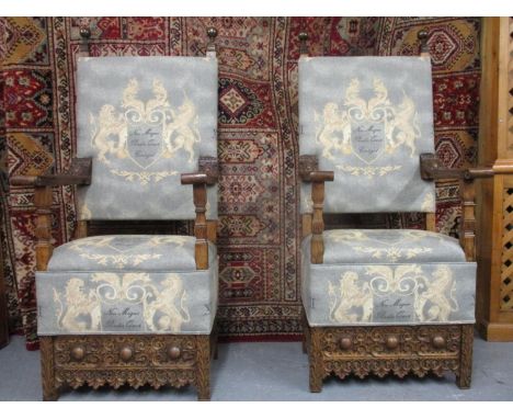 A pair of 17th/18th century Spanish walnut throne chairs, with level, carved arms and square supports, upholstered in a tapes