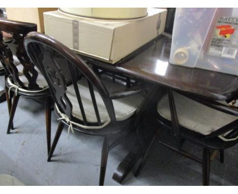 Mid 20th century dark Ercol furniture to include a dining table, dining chairs and a dresser 