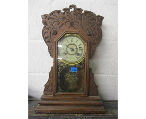 An early 20th century American New Haven Clock Company mantle clock in a carved mahogany case, 21 3/4" h 