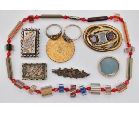 A BAG OF ASSORTED ITEMS, to include a gold plated oval open work brooch, set with two oval cut amethysts and an emerald cut b