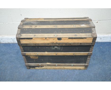 A DOMED TRAVELING TRUNK, with wooden and metal banding, twin handles and a hinged lid, width 77cm x depth 49cm x height 57cm 