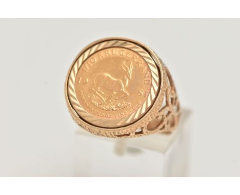 A KRUGERRAND RING, a 1981 Krugerrand 1/10&nbsp; coin, mounted in a textured open work ring mount, ring size R 1/2 leading edg