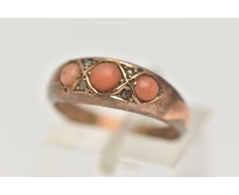 A LATE VICTORIAN 9CT GOLD, THREE STONE CORAL RING, set with three circular cut coral cabochons, with four small rose cut diam