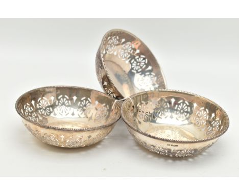 THREE GEORGE V BONBON DISHES, the first a circular form dish with pierced detail and gadrooned edge, approximate diameter 123
