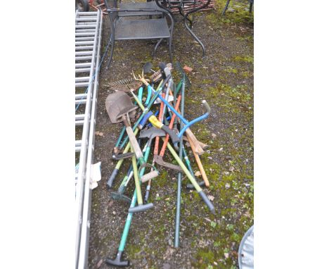 A COLLECTION OF GARDEN TOOLS including rakes, shovels, bolt croppers , edging tools etc
