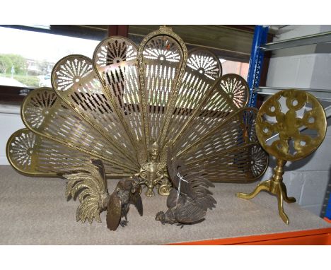 A BRASS PEACOCK FIRESCREEN, approximate height 62cm, together with a small brass tilt top table, approximate height 30cm and 