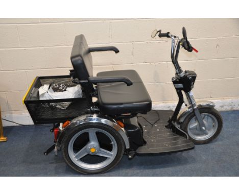 AN AFIKIM TWO SEAT TRICYCLE MOBILITY SCOOTER with charger, one key, rear basket, lights and indicators