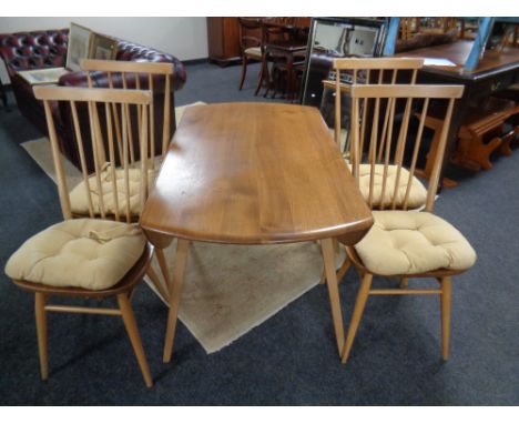 An Ercol elm and beech drop leaf dining room table and four stick back armchairs 