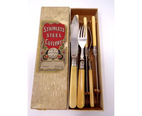 A stainless steel fish knife and fork set with silver ferrules 