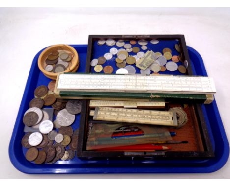 A tray of British and European coins, rulers, vintage tape measures etc 