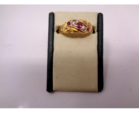 A Victorian ruby and diamond 18ct yellow gold five stone ruby ring, three graduated rubies with two small round old cut diamo