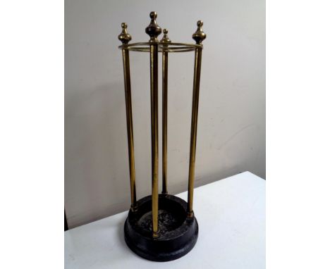 A brass stick stand on iron base, height 60 cm.