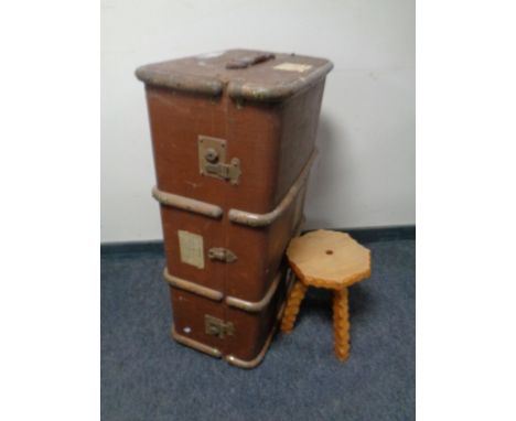 A small rustic tripod stool and a vintage shipping trunk 