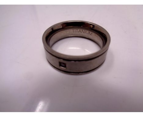 A titanium gent's band ring set with a stone 