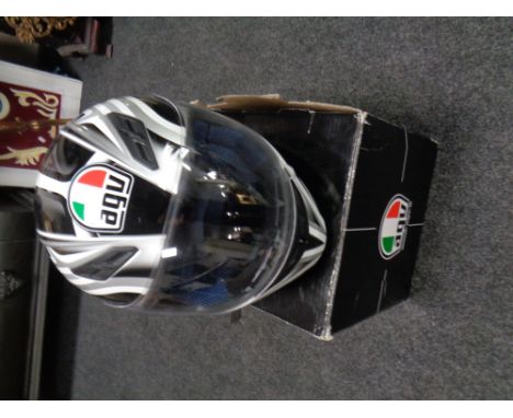 An AGU motorcycle helmet in box 