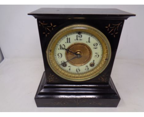 A 19th century painted metal mantel clock with brass and enamelled dial 