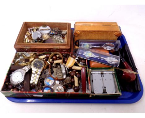 A tray of wristwatches, pen knife, wooden crucifix on bead necklace, cast metal crucifix, pipe, vintage dominoes, travel cloc
