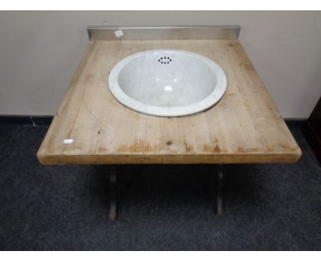 A reclaimed pine sink unit with antique ceramic sink on a cast iron base 