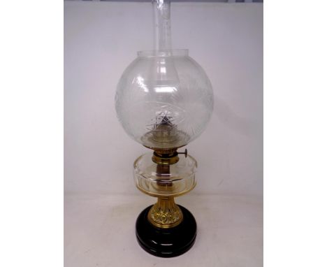 A 19th century German brass and glass oil lamp with chimney and shade